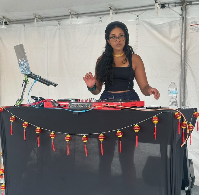 DJ Xhama on the decks at a festival tent